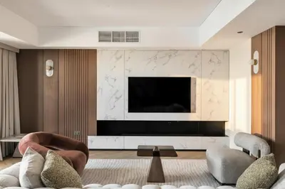 a living room with a television on a wall at Luxury 4 Bedroom Penthouse in Dubai Marina in Dubai