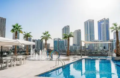 a swimming pool with a city skyline in the background at Luxury 4 Bedroom Penthouse in Dubai Marina in Dubai