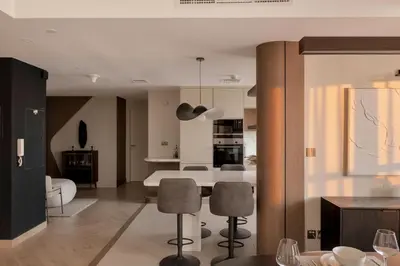 a kitchen and living room with a table and chairs at Luxury 4 Bedroom Penthouse in Dubai Marina in Dubai
