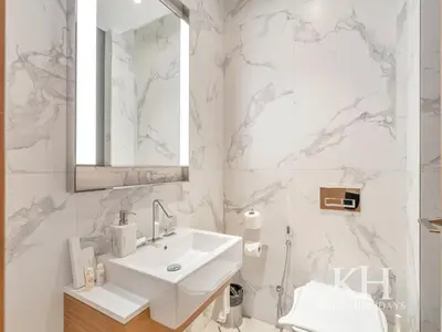 a white bathroom with a sink and a mirror at keylid-2BR-Address Opera-5 mins walk to Dubai Mall in Dubai