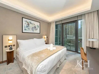a bedroom with a large bed and a large window at keylid-2BR-Address Opera-5 mins walk to Dubai Mall in Dubai