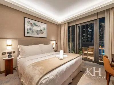 a bedroom with a large bed and a large window at keylid-2BR-Address Opera-5 mins walk to Dubai Mall in Dubai