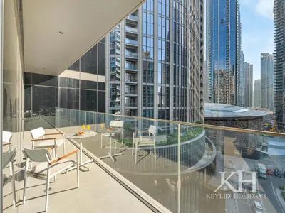 a balcony with a table and chairs on a building at keylid-2BR-Address Opera-5 mins walk to Dubai Mall in Dubai