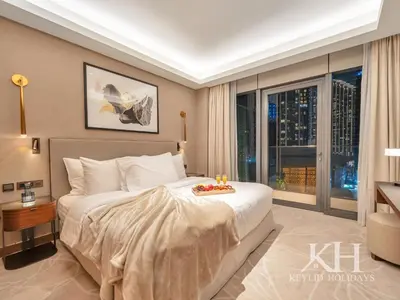 a bedroom with a large bed and a large window at keylid-2BR-Address Opera-5 mins walk to Dubai Mall in Dubai