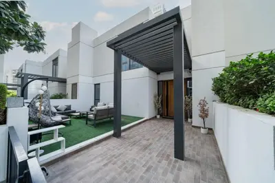 an outdoor patio with awning on a house at Dubai Hills Townhouse in Dubai