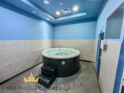 a bathroom with a hot tub in a room with blue ceilings at Central Park towers residence difc in Dubai
