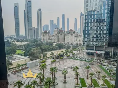 a view of a city with palm trees and buildings at Central Park towers residence difc in Dubai