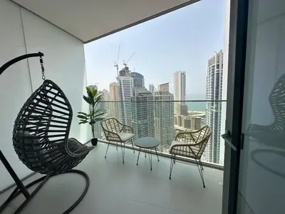 a balcony with chairs and a view of the city at Royal suite at Liv marina views in Dubai