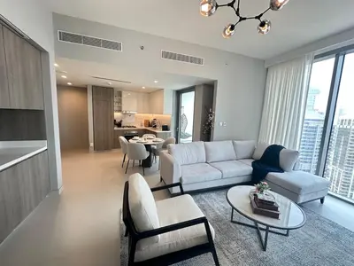 a living room with a couch and a table at Royal suite at Liv marina views in Dubai