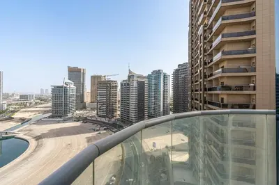 a view of a city from the balcony of a building at 2-Bedroom Haven with Canal View near The Els Club in Dubai