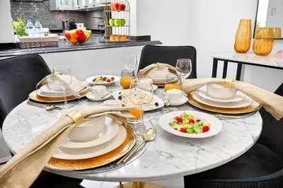 a table with plates and bowls of food on it at Arabian Elegance 1BR Zanzabeel 1 Burj Khalifa View in Dubai