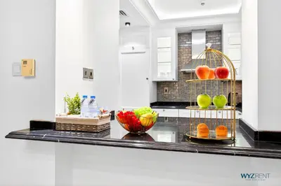 a kitchen with fruits and vegetables on a counter at Arabian Elegance 1BR Zanzabeel 1 Burj Khalifa View in Dubai