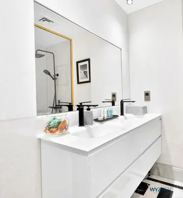 a white bathroom with a sink and a large mirror at Arabian Elegance 1BR Zanzabeel 1 Burj Khalifa View in Dubai