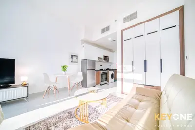 a living room with a couch and a table at Elz Residence Stylish Studio Living in Dubai