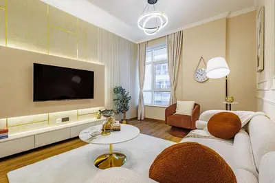 a living room with a couch and a tv at Elegant Oasis - 15 min to Burj Khalifa and Aiport - 1 BDR - 4 pax in Dubai