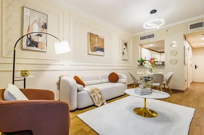 a living room with a couch and a table at Elegant Oasis - 15 min to Burj Khalifa and Aiport - 1 BDR - 4 pax in Dubai
