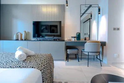 a hotel room with a bed and a table and chairs at TRPS - MAG 318, Business Bay - Spacious Studio, Furnished, Close to Dubai Mall in Dubai