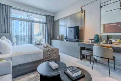 a hotel room with a bed and a desk at TRPS - MAG 318, Business Bay - Spacious Studio, Furnished, Close to Dubai Mall in Dubai