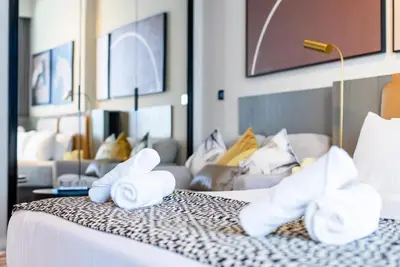 a hotel room with a bed with towels on it at TRPS - MAG 318, Business Bay - Spacious Studio, Furnished, Close to Dubai Mall in Dubai