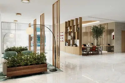 a lobby with a table and chairs and plants at Vintage Grand Hotel Apartments Dubai in Dubai