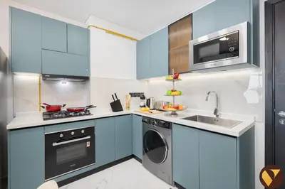 a blue kitchen with a sink and a dishwasher at Vogue Arjan Opalz by Danube near Science Park, One Bedroom Apartment with Balcony and Vibrant Community View, Access to all Amenitties in Dubai