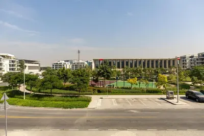 an empty parking lot in front of a building at Maison Privee - Chic & Eclectic Family Home with Park Vws in Meydan in Dubai