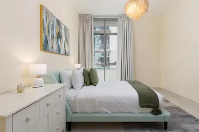 a bedroom with a bed and a dresser and a window at Maison Privee - Chic & Eclectic Family Home with Park Vws in Meydan in Dubai