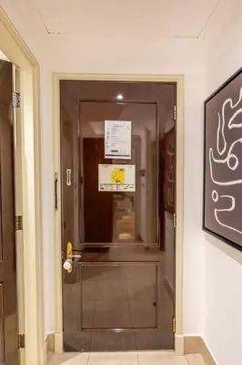 a door in a hallway with a sign on it at Charming 1 BR with Burj Khalifa View in Dubai