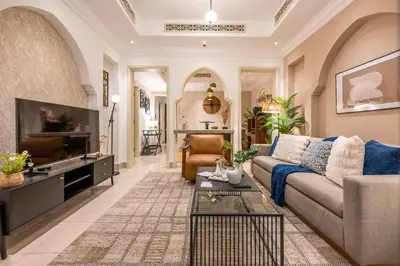 a living room with a couch and a tv at Charming 1 BR with Burj Khalifa View in Dubai