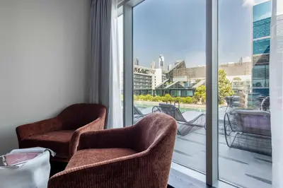 two chairs in a room with a view of a balcony at Frank Porter - J One Tower 2 in Dubai