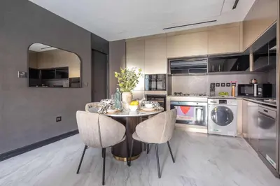a kitchen with a table and chairs and appliances at Frank Porter - J One Tower 2 in Dubai