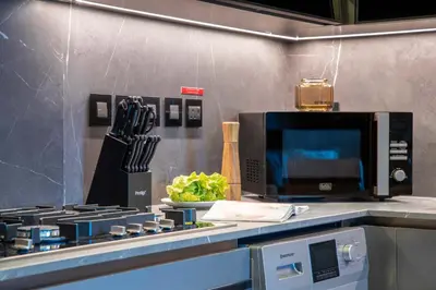a kitchen with a stove and a microwave at Frank Porter - J One Tower 2 in Dubai