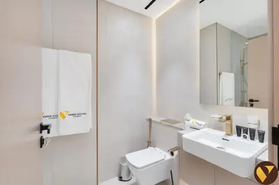 a white bathroom with a sink and a toilet at Vogue JVC Binghatti Dawn near Circle Mall, Studio Apartment with Balcony and Vibrant Community View, Access to all Amenities in Dubai