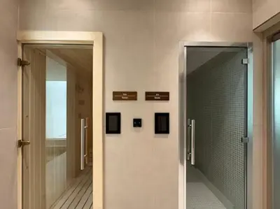a bathroom with a walk in shower and a glass door at Vogue JVC Binghatti Dawn near Circle Mall, Studio Apartment with Balcony and Vibrant Community View, Access to all Amenities in Dubai