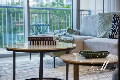 a living room with two tables and a couch at Luxury 2BR Harbour Views Tower 2 Creek Harbour Dubai in Dubai