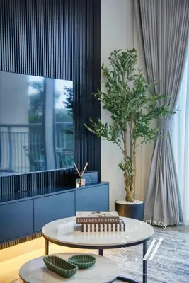 a living room with a table and a potted tree at Luxury 2BR Harbour Views Tower 2 Creek Harbour Dubai in Dubai