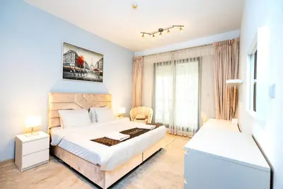 a bedroom with a large white bed and a window at Escape24 Elegant 1BR with Marina Views, Dubai Marina in Dubai