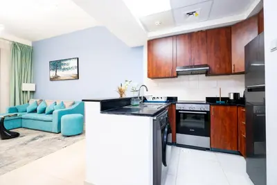 a kitchen with a sink and a stove at Escape24 Elegant 1BR with Marina Views, Dubai Marina in Dubai