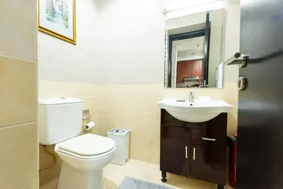 a bathroom with a toilet and a sink at Escape24 Elegant 1BR with Marina Views, Dubai Marina in Dubai