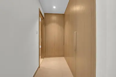 a hallway with wooden doors and a hallway at 3 Bedroom in Creek Habour with Scenic Views for Family and Solo Travelers in Dubai