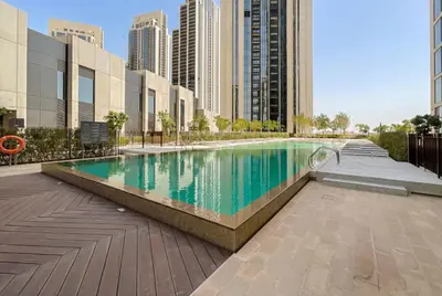a swimming pool in a city with tall buildings at 3 Bedroom in Creek Habour with Scenic Views for Family and Solo Travelers in Dubai