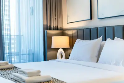 a hotel room with a bed and a lamp at TRPS - MAG 318, Business Bay - Pool View, 2BR Fully Furnished, Prime Location in Dubai