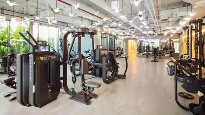 a gym with several treadmills and cardio machines at TRPS - MAG 318, Business Bay - Pool View, 2BR Fully Furnished, Prime Location in Dubai