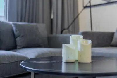 a table with three candles sitting on top of it at TRPS - MAG 318, Business Bay - Pool View, 2BR Fully Furnished, Prime Location in Dubai