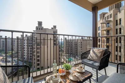 a balcony with a table and a chair on a balcony at Frank Porter - Jadeel 3 in Dubai