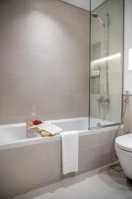 a bathroom with a bath tub and a toilet at Frank Porter - Jadeel 3 in Dubai