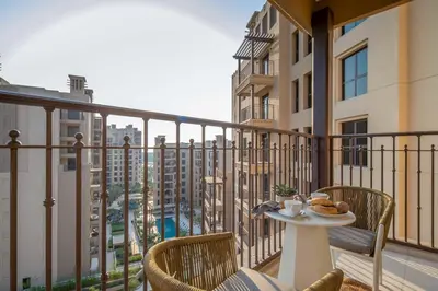 a balcony with a table and chairs with a view at Frank Porter - Jadeel 3 in Dubai