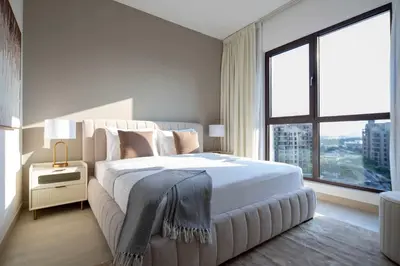 a bedroom with a large bed and a large window at Frank Porter - Jadeel 3 in Dubai