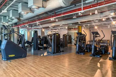 a gym with treadmills and elliptical machines at Frank Porter - Downtown Views II Tower 1 in Dubai