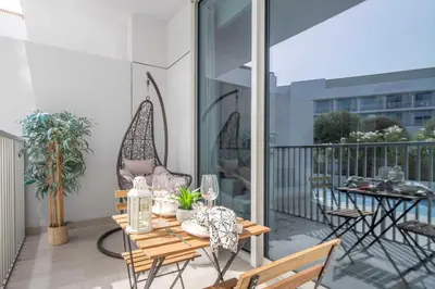 a patio with a table and chairs on a balcony at Frank Porter - Luma22 West Tower in Dubai